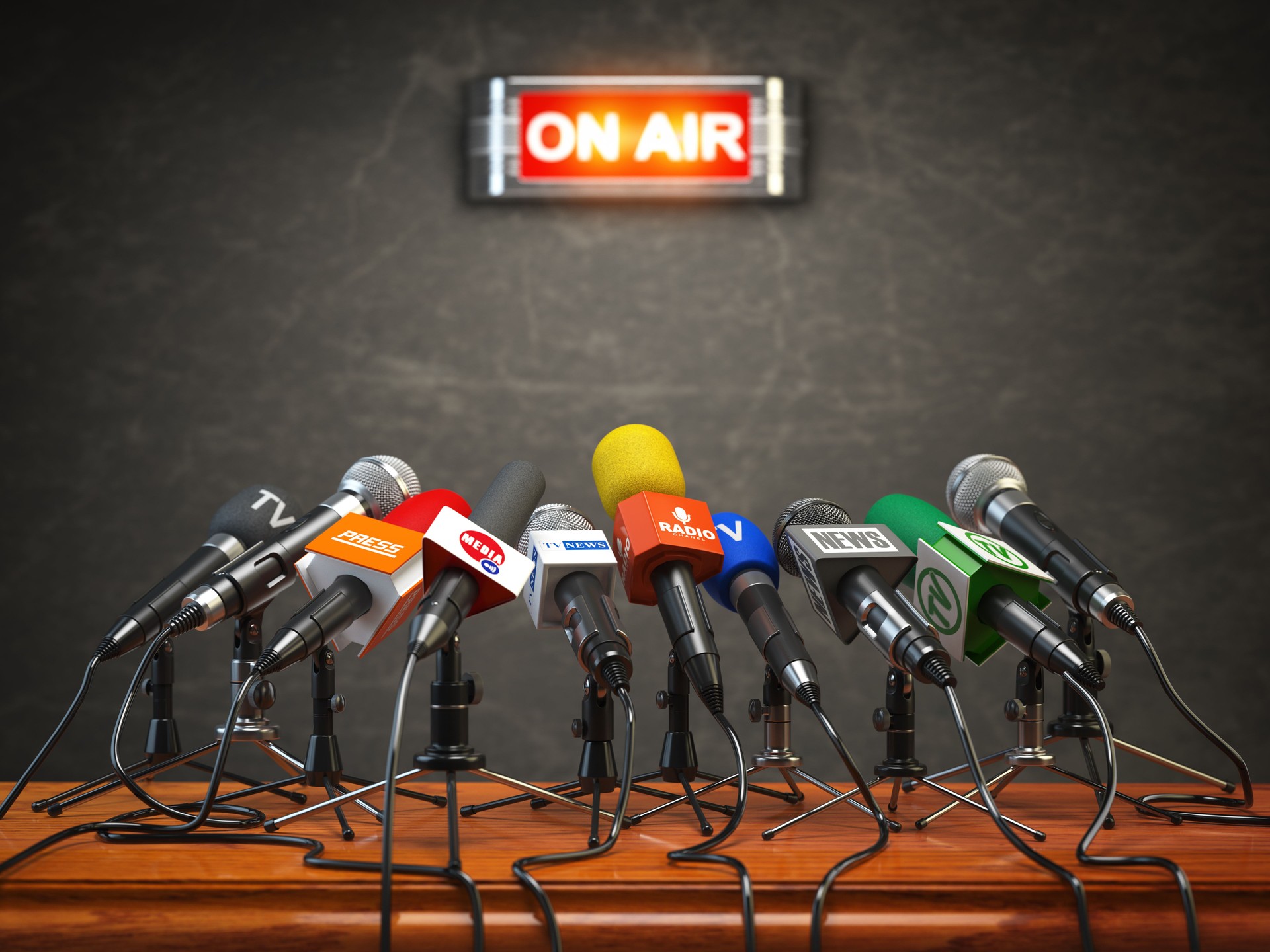 Press conference or interview on air.  Microphones of different mass media, radio, tv and press prepared for conference meeting.